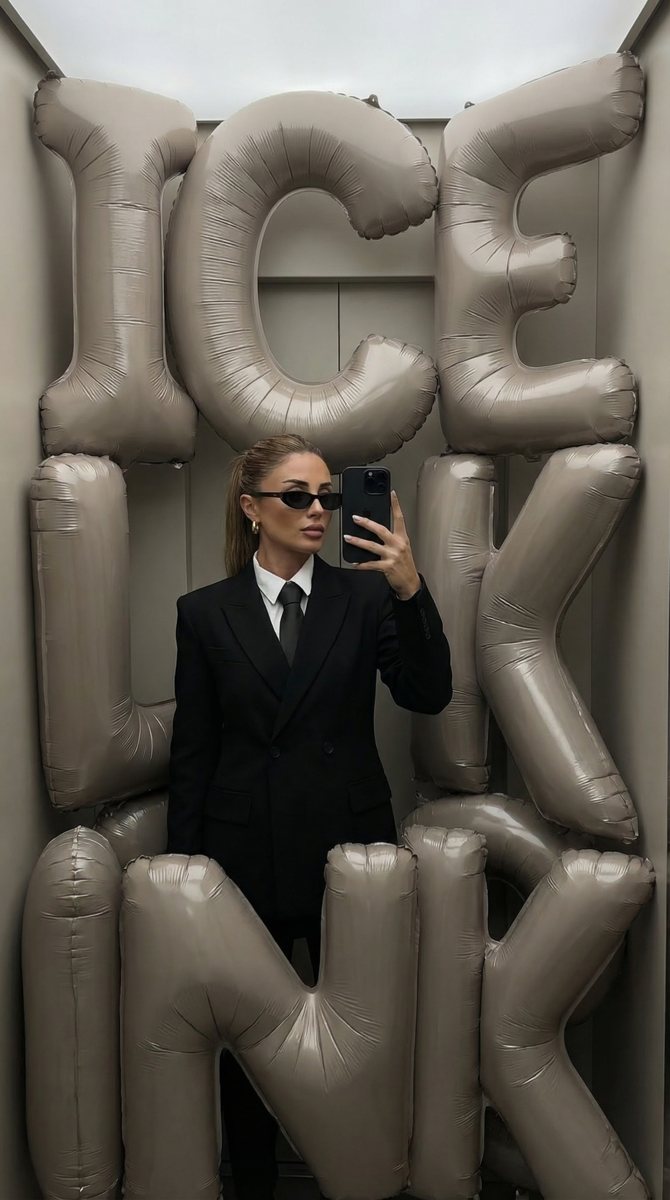 AI image: mirror selfie framed by giant IceLink balloon letters