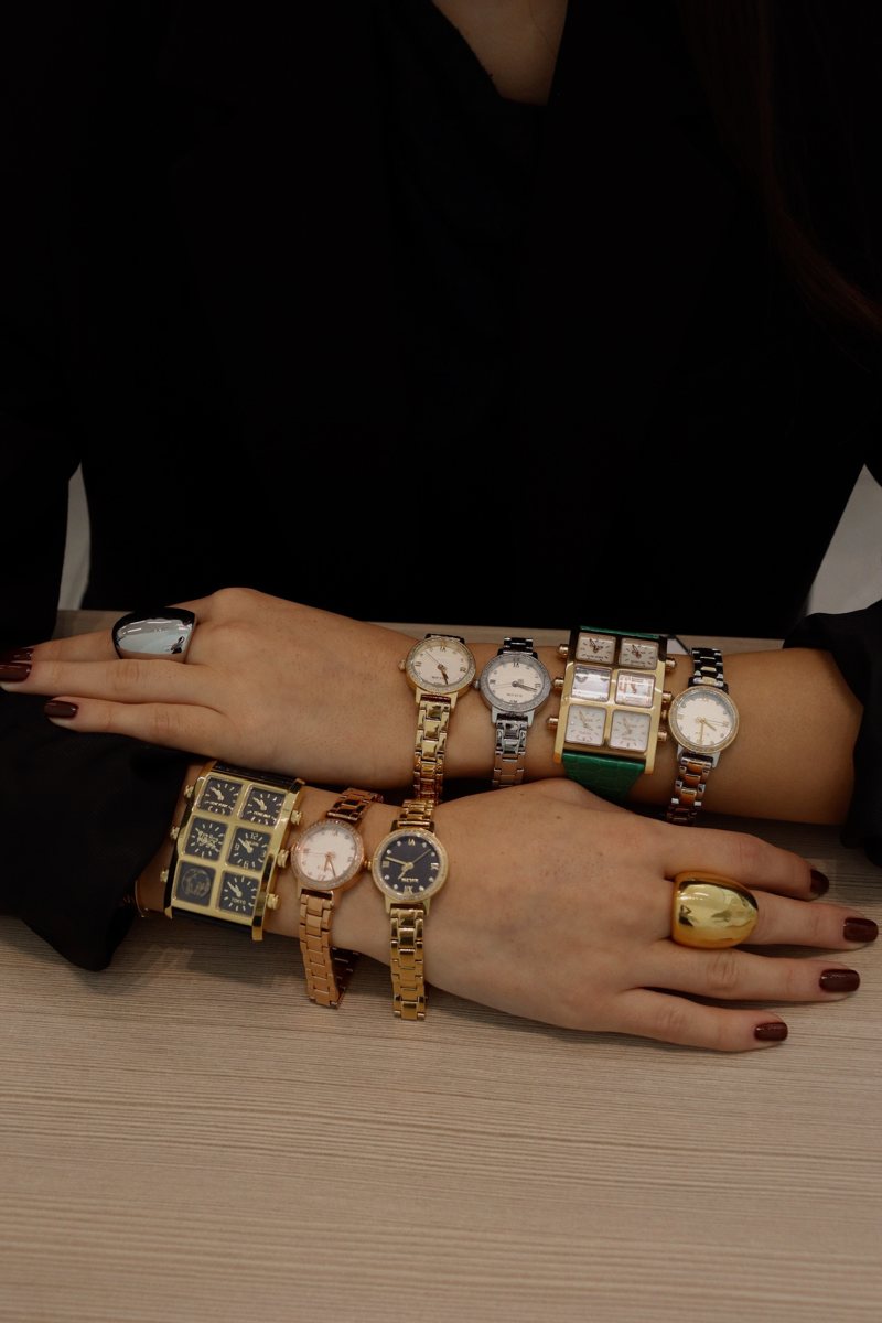 Arms stacked with IceLink watches and bold rings