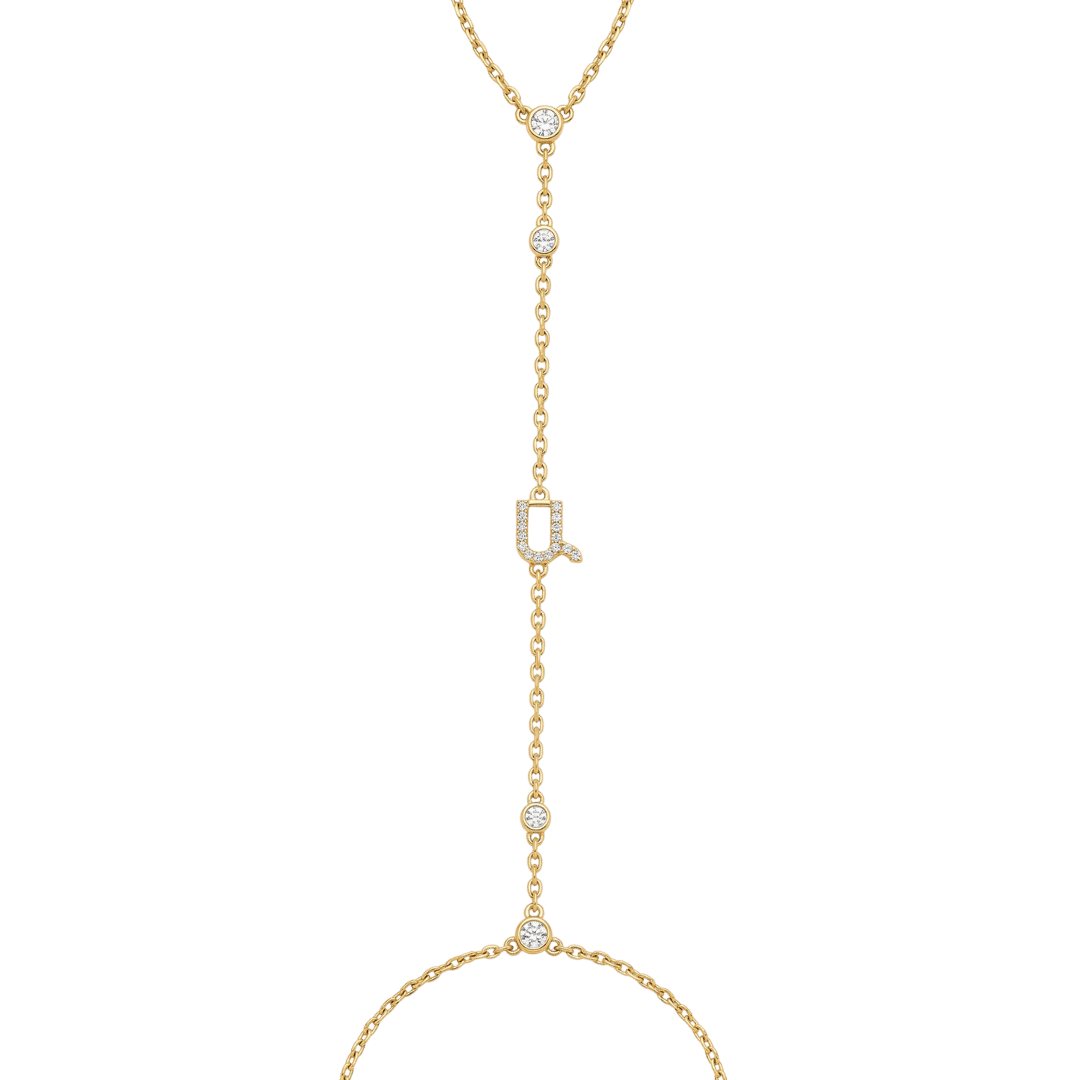 Gold initial body chain with bezel diamonds on white