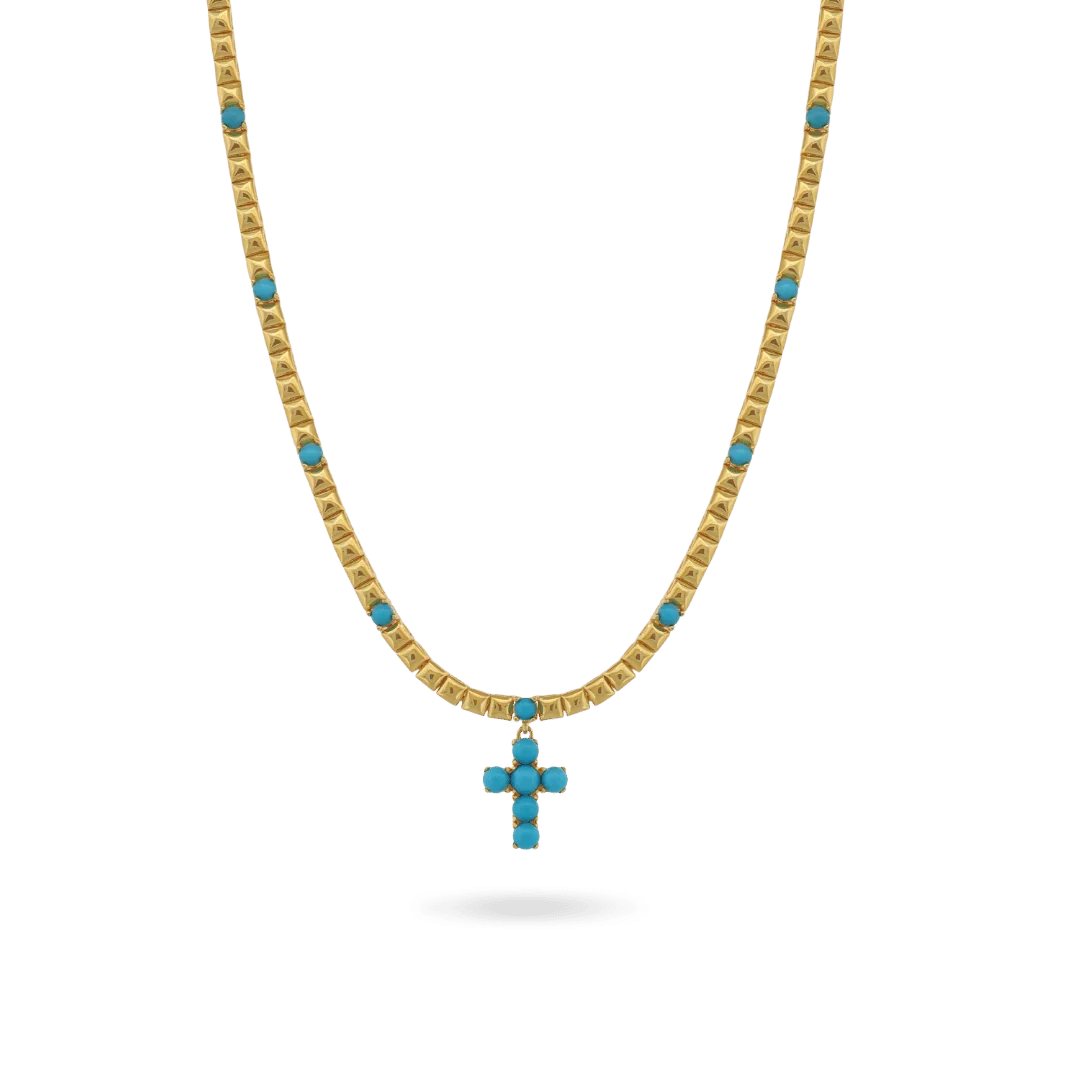 Gold necklace with turquoise cross pendant on white